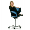 Woman straddling the back of HAG Capisco ergonomic saddle seat