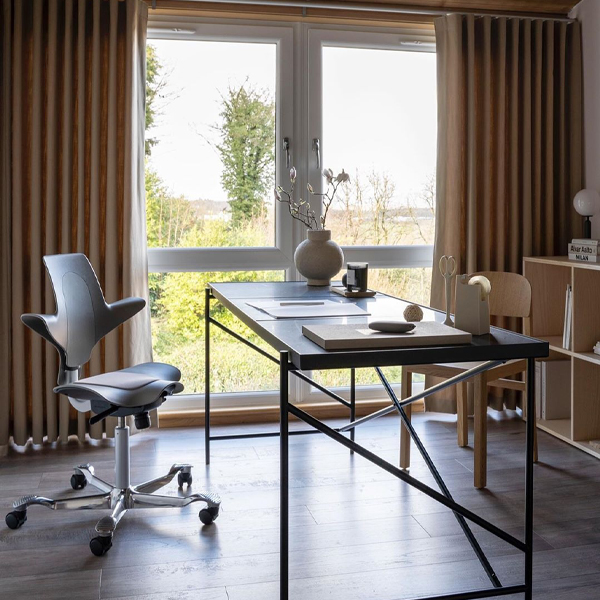 hag puls chair brown in home office environment with large window