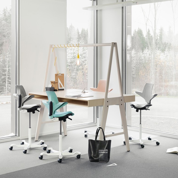 bright home office with large windows and colorful desk chairs