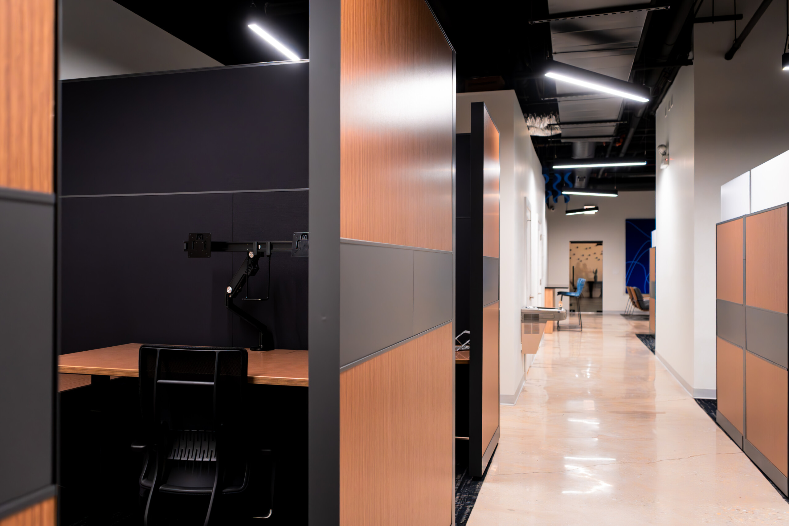 Hallway with view of workstations and custom lighting